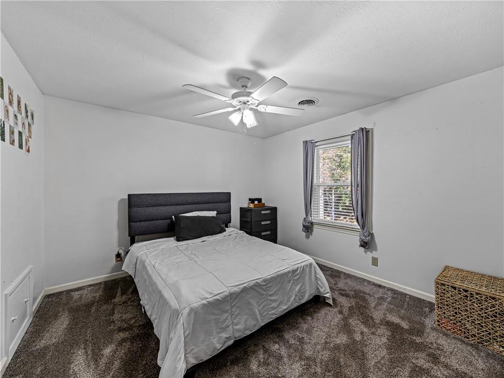 215 Pineywood Road Griffin, GA 30224 - Photo 30 of 49 a bedroom with a bed and a chandelier