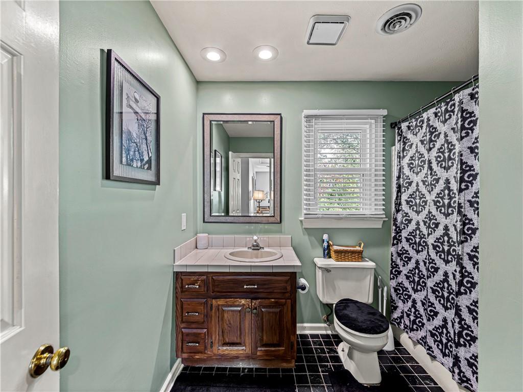 215 Pineywood Road Griffin, GA 30224 - Photo 31 of 49 a bathroom with a toilet sink and mirror