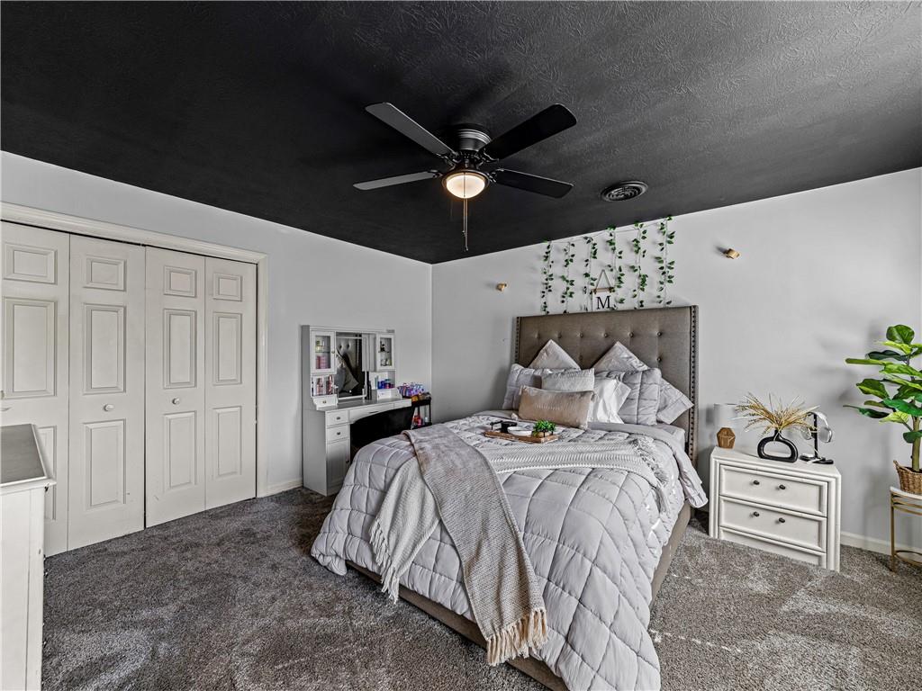 215 Pineywood Road Griffin, GA 30224 - Photo 32 of 49 a bed room with a bed and a chandelier