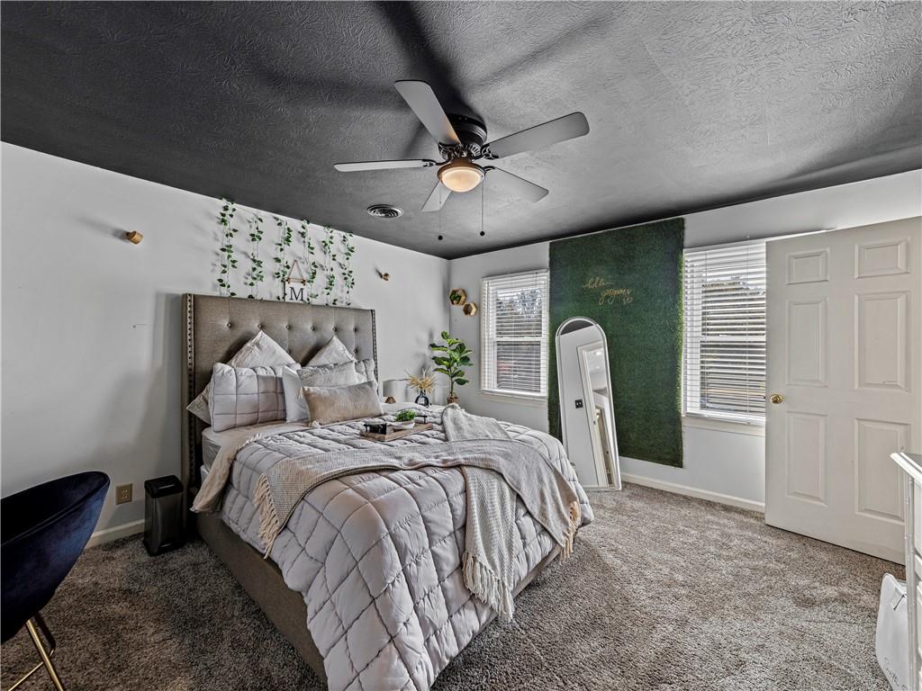215 Pineywood Road Griffin, GA 30224 - Photo 33 of 49 a bed room with a bed mirror and a window