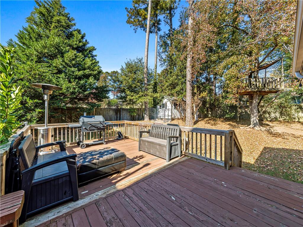 215 Pineywood Road Griffin, GA 30224 - Photo 42 of 49 a balcony with wooden floor and outdoor seating
