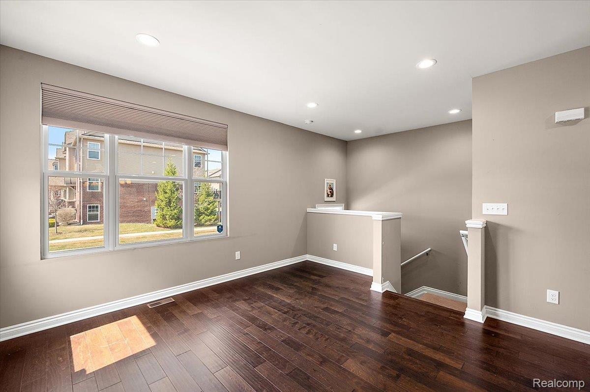 2877 Hartwick Drive Rochester, MI 48307 - Photo 15 of 44 Unfurnished room featuring dark wood-style flooring and recessed lighting
