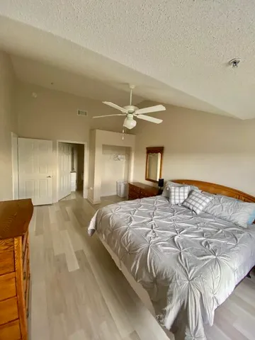 a bedroom with a bed and a mirror