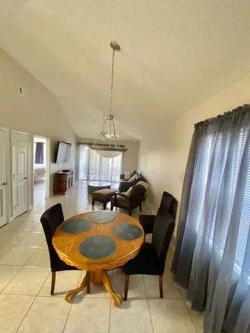 a view of a livingroom with furniture and a window