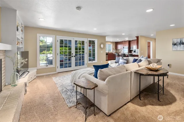 a living room with fireplace furniture and a large window