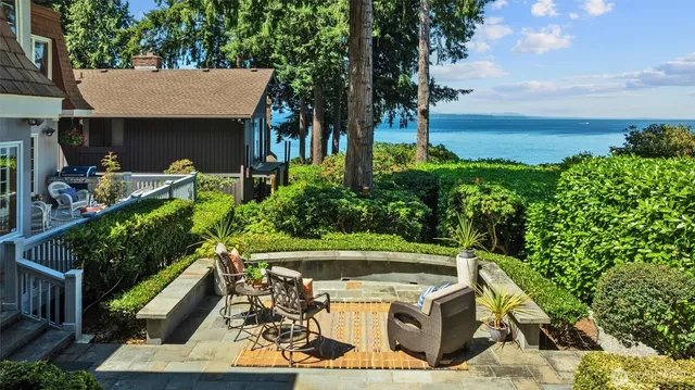 a view of a house with garden and a sitting area