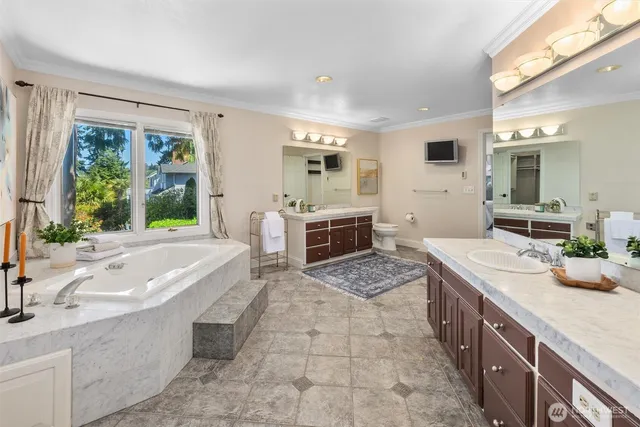 a spacious bathroom with a granite countertop tub sink and mirror