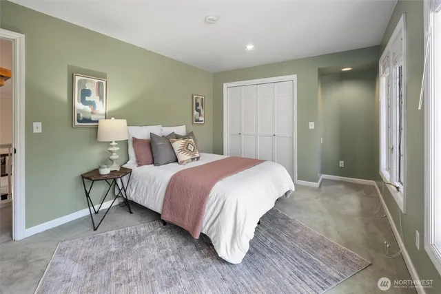 a bedroom with a bed and night stand