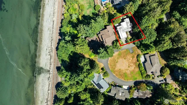 an aerial view of a house with a yard and garden