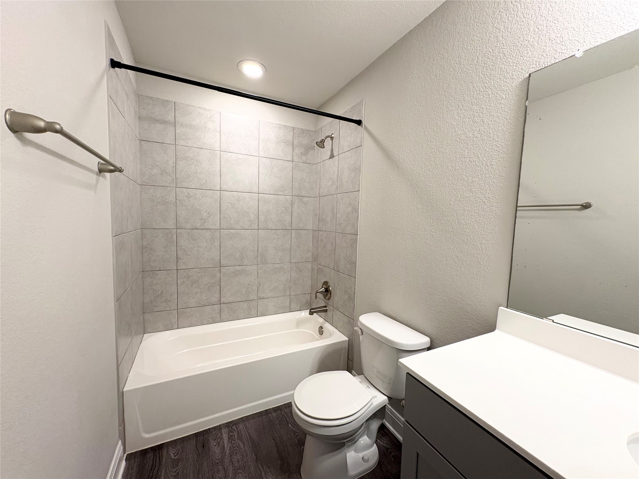 16103 Windroot Street Austin, TX 78728 - Photo 25 of 32 Modern finishes define this bathroom featuring a tiled tub surround and clean vanity lines.