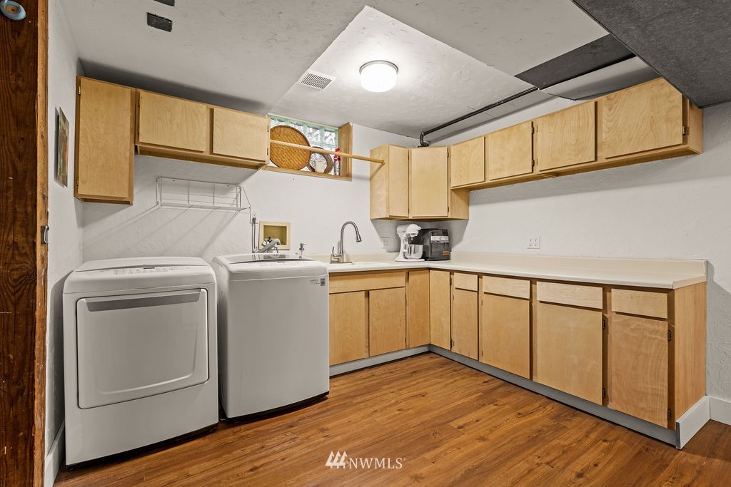 2002 Madrona Point Bremerton, WA 98312 - Photo 21 of 40 a view of a kitchen with sink and wooden floor