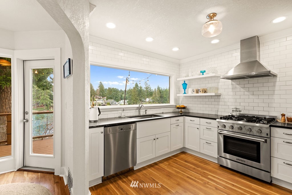 2002 Madrona Point Bremerton, WA 98312 - Photo 7 of 40 a kitchen with stainless steel appliances granite countertop a stove and a sink