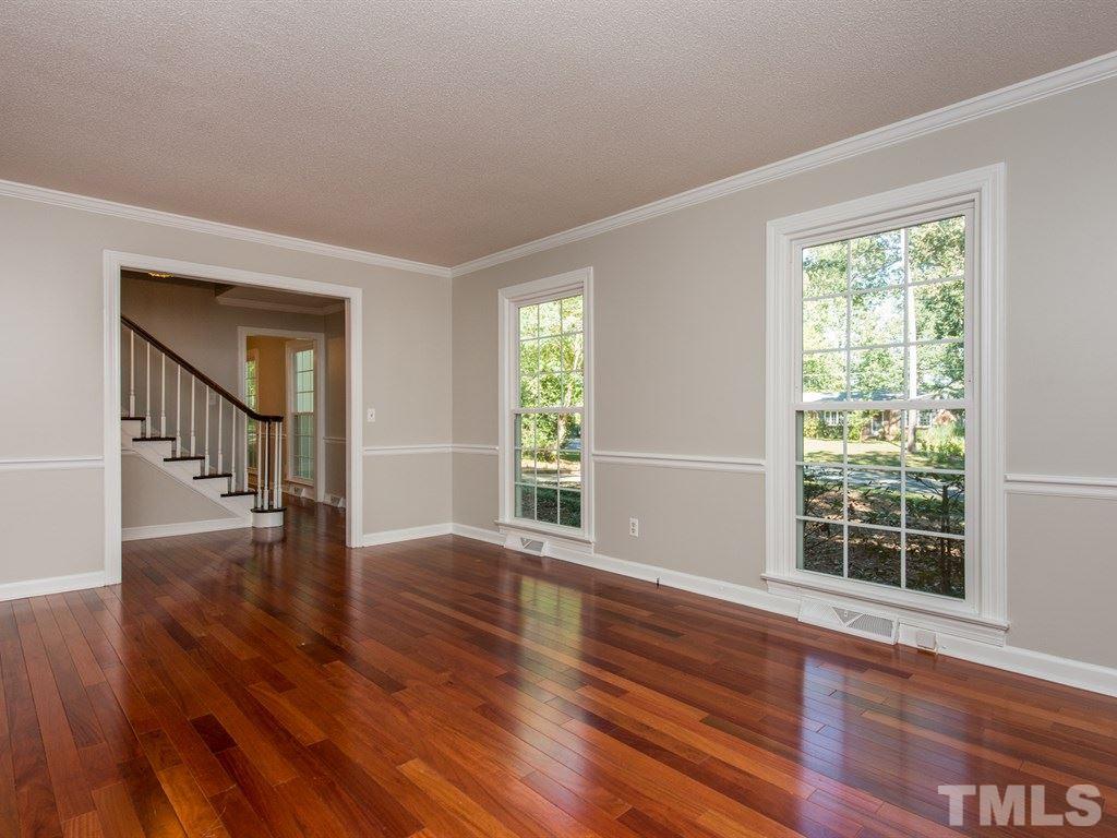 6925 Electra Drive Raleigh, NC 27607 - Photo 2 of 25 a view of an empty room with wooden floor and a window