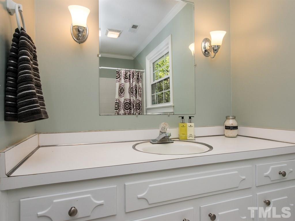 6925 Electra Drive Raleigh, NC 27607 - Photo 19 of 25 a bathroom with a sink and a mirror