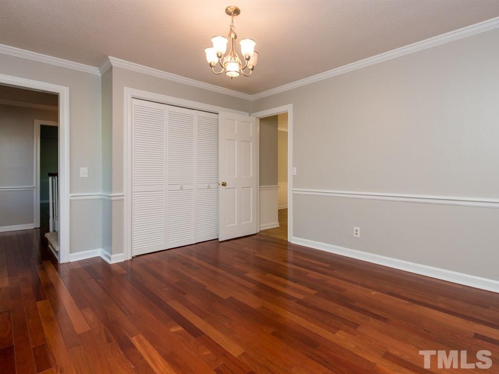 6925 Electra Drive Raleigh, NC 27607 - Photo 4 of 25 wooden floor in an empty room with a window