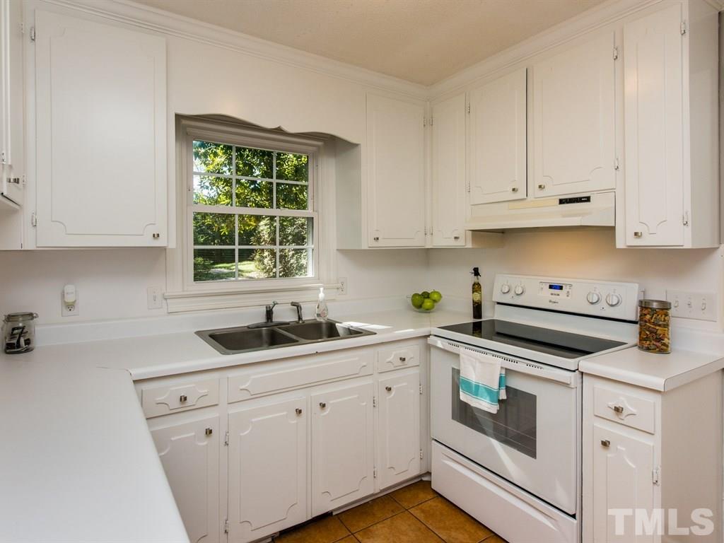 6925 Electra Drive Raleigh, NC 27607 - Photo 5 of 25 a kitchen with white cabinets and white appliances