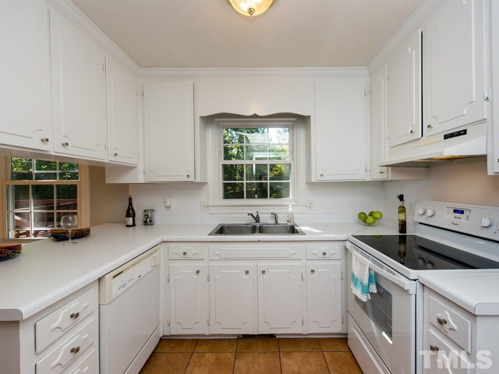 6925 Electra Drive Raleigh, NC 27607 - Photo 6 of 25 a kitchen with a white cabinets and window