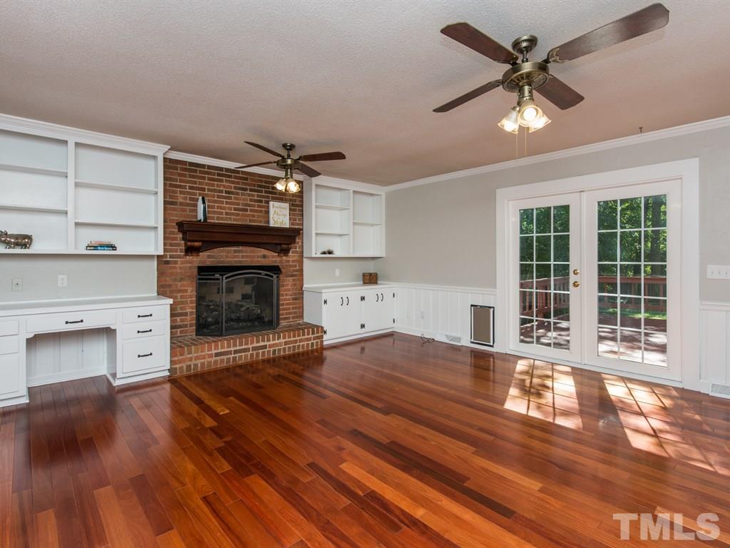 6925 Electra Drive Raleigh, NC 27607 - Photo 9 of 25 a living room with a fireplace with wooden floor