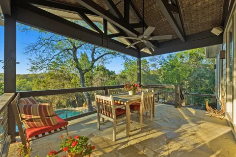 a view of a chairs and table in the balcony