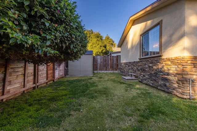 a view of a house with a backyard