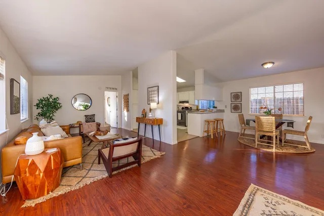a living room with furniture and wooden floor