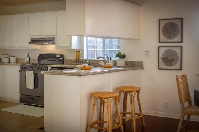 a kitchen with appliances cabinets and furniture
