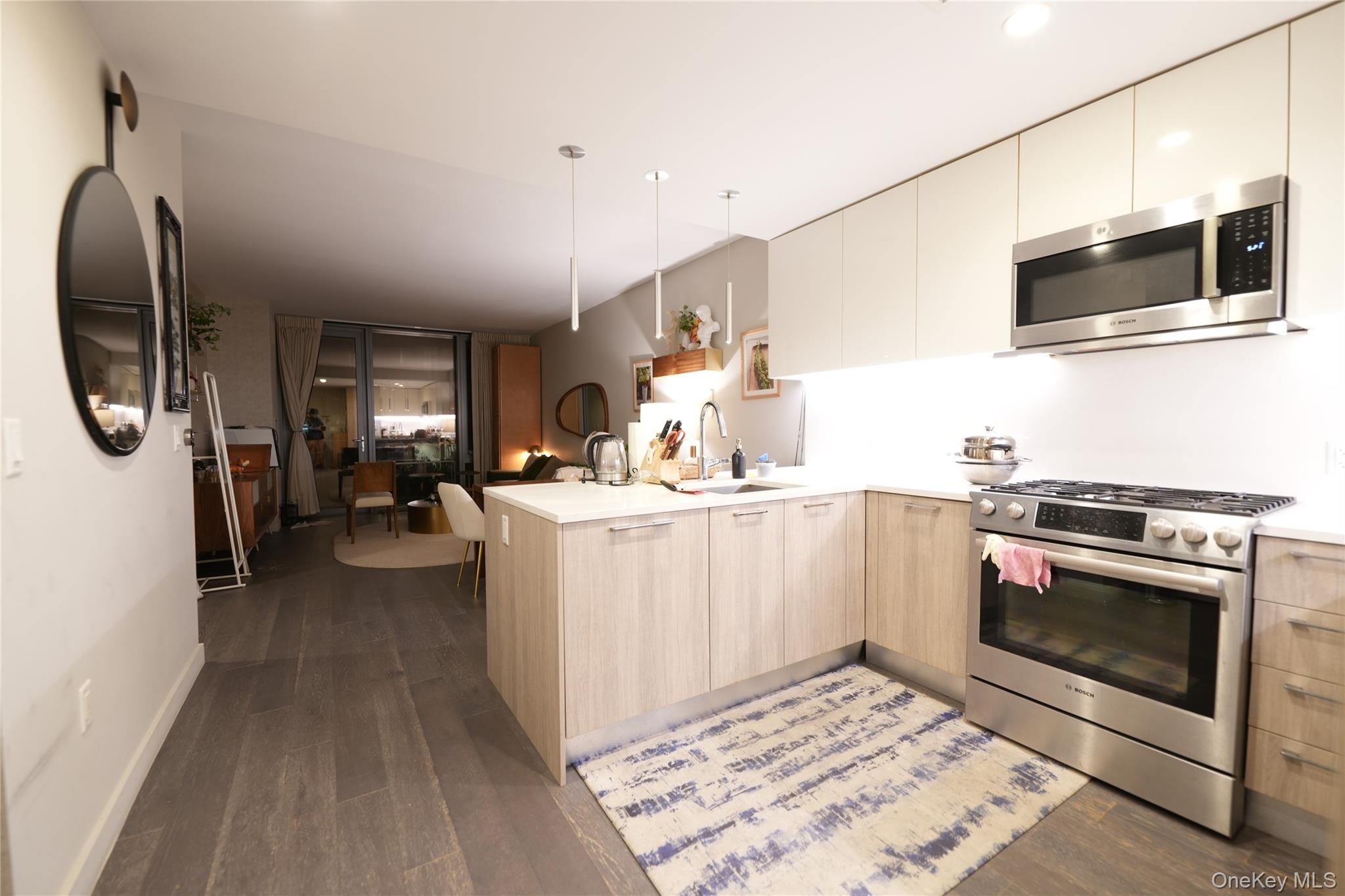 a kitchen with sink cabinets and microwave