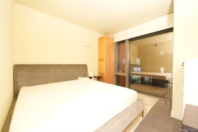 a spacious bedroom with a bed and a view of bathroom