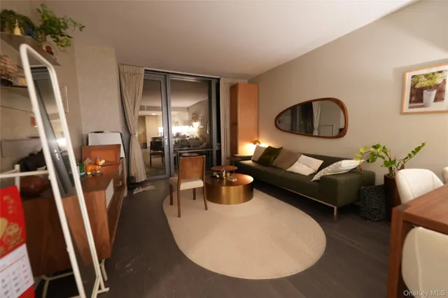 a living room with furniture and a floor to ceiling window