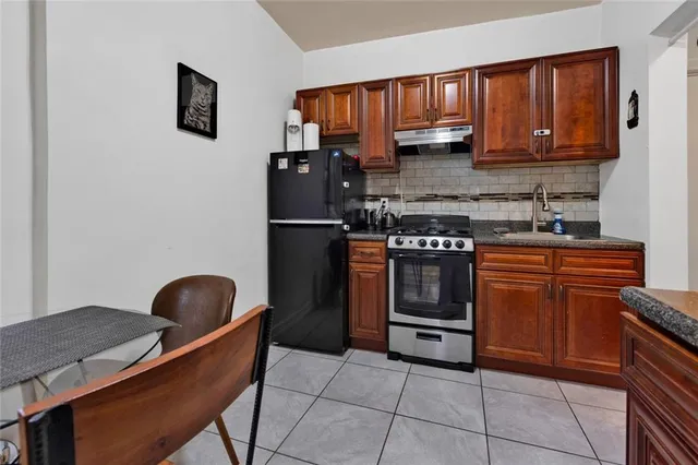 a kitchen with a stove a microwave and wooden cabinets