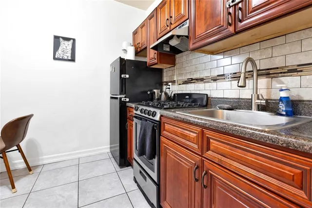 a kitchen with stainless steel appliances granite countertop a stove and a sink
