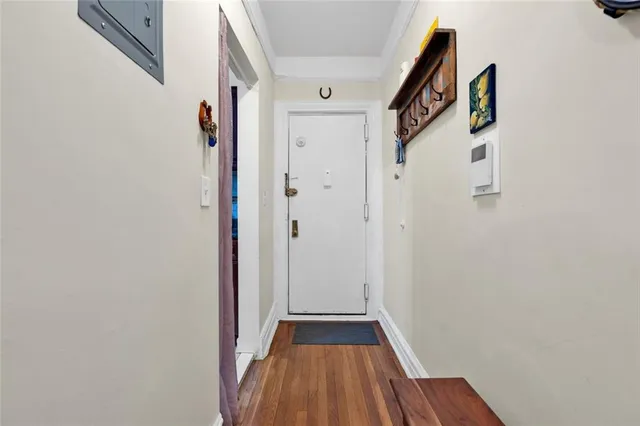 a view of a hallway with wooden floor and staircase