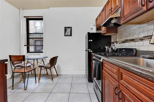 a kitchen with stainless steel appliances granite countertop a sink and cabinets