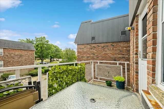 a view of a chairs and table in the balcony