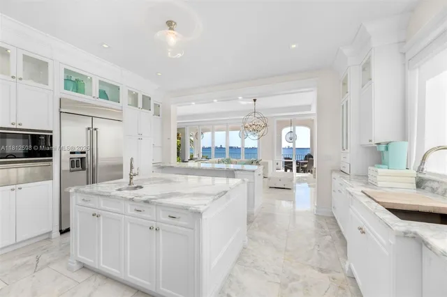 a large white kitchen with cabinets