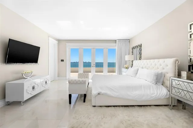 a bedroom with a bed and a large window