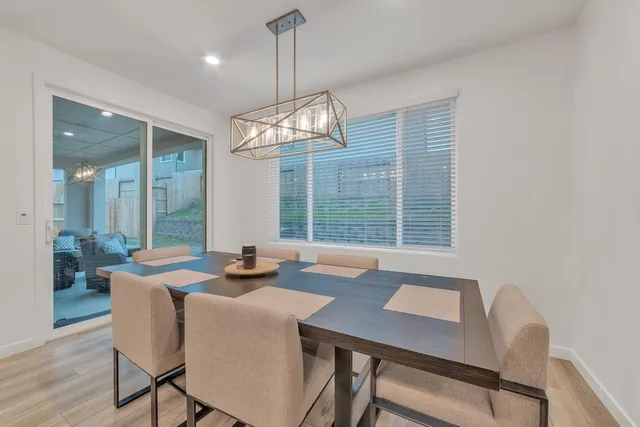 a view of a dining room with furniture wooden floor and chandelier