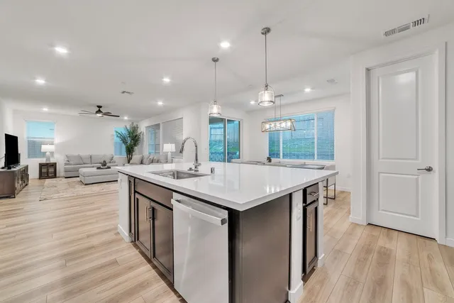a kitchen with a sink and wooden floor
