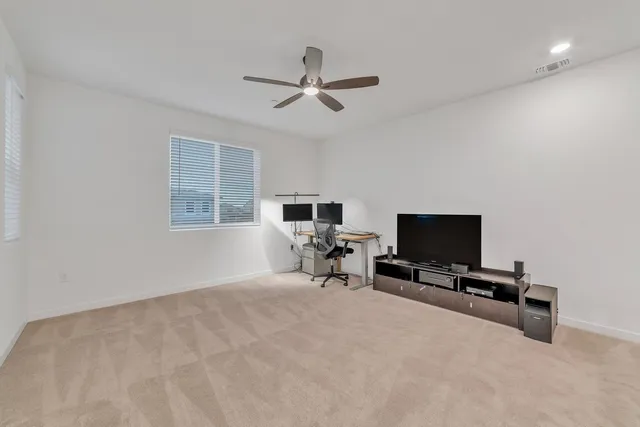 a view of a livingroom with a flat screen tv and a window