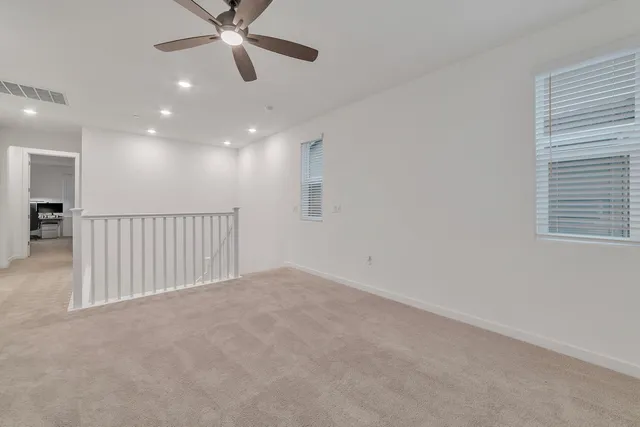 a view of a livingroom with a ceiling fan and window