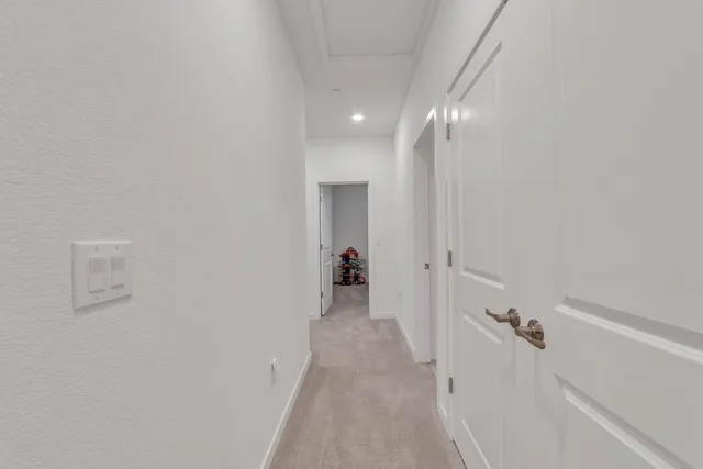 a view of a hallway with wooden shelves
