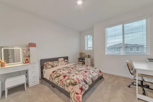 a bedroom with a bed and a desk