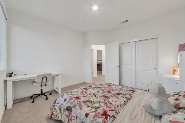 a bedroom with a bed and window