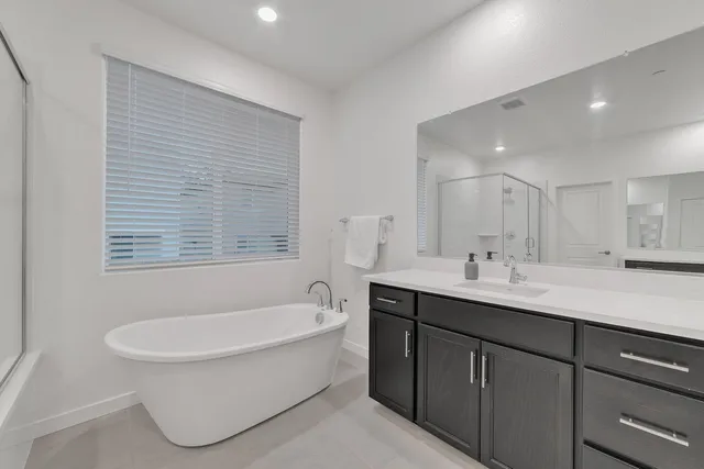 a bathroom with a sink vanity and mirror