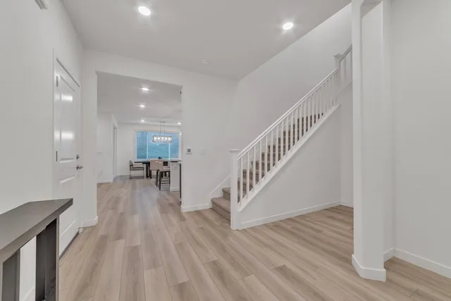 a view of entryway and hall with wooden floor