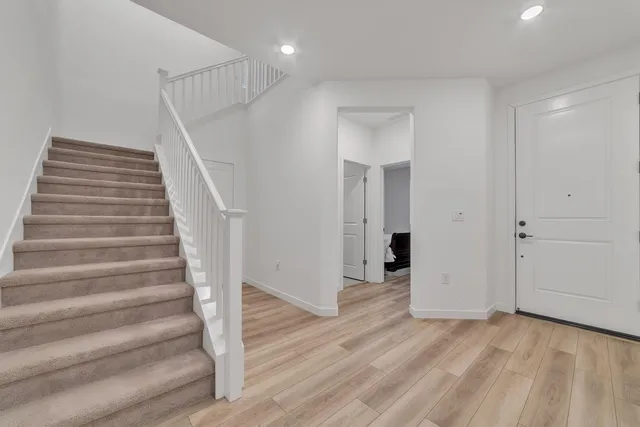 a view of entryway with wooden floor and stairs