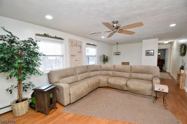 a living room with furniture and a potted plant