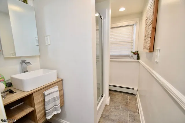a bathroom with a sink dryer and window