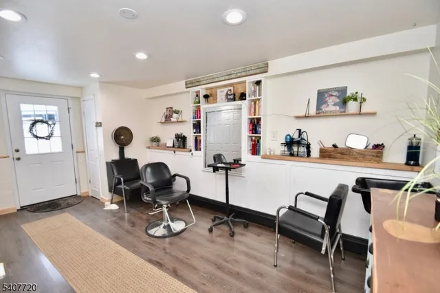 a room with furniture a rug and white walls