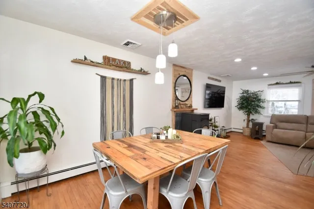 a view of a dining room with furniture and wooden floor